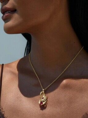 Awe Inspired Gold Scorpion Necklace With Garnet